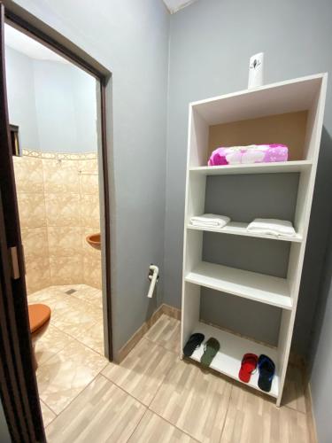 a bathroom with a mirror and a towel rack at Ñande Roga in Asunción