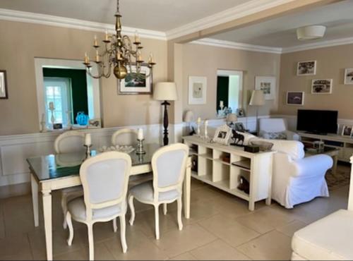 a living room with a dining table and a couch at Herdade de Santa Maria in Almeirim