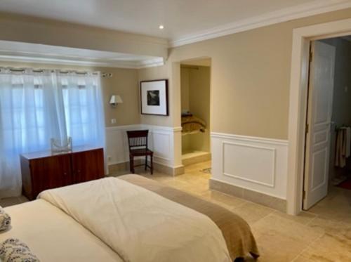 a bedroom with a bed and a chair in it at Herdade de Santa Maria in Almeirim