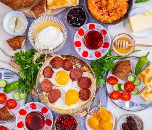 a table topped with plates of food with meatballs and eggs at Herdade de Santa Maria in Almeirim