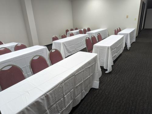 a row of white tables and chairs in a room at Sleep Inn Pelham Oak Mountain in Pelham
