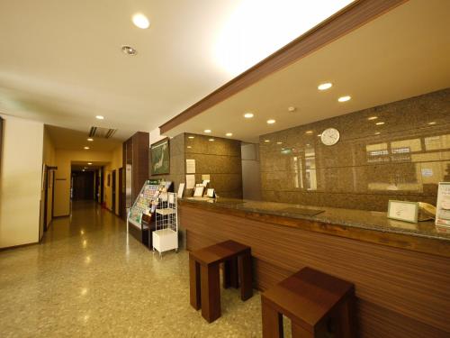 a restaurant with two tables and a counter at Hotel Route-Inn Court Uenohara in Uenohara