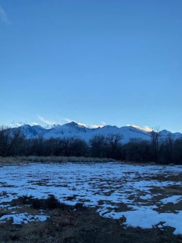 a snow covered field with mountains in the background at Starlight Motel in Big Pine