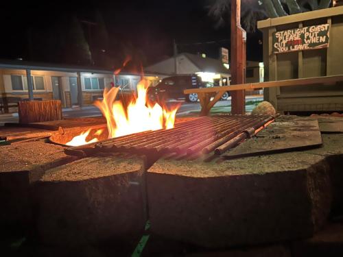 a grill with fire in the middle of a street at Starlight Motel in Big Pine