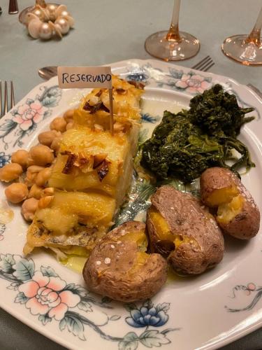 a plate of food with vegetables and meat on a table at Herdade de Santa Maria in Almeirim