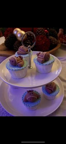 a white plate with four cupcakes on top at Herdade de Santa Maria in Almeirim