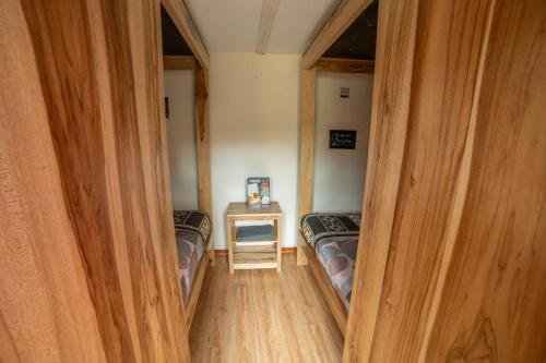 a small room with two beds and a table at The Secret Garden in Quito
