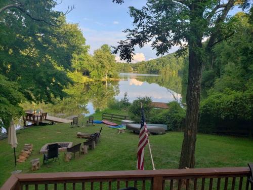 a view of a lake with benches and a boat at Waterfront Cabin 20 Mins to National Park & Massanutten! in Stanardsville