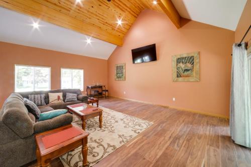a living room with a couch and a tv at Spacious House on Half Acre Less Than 3 Mi to Beach! in Sawyer