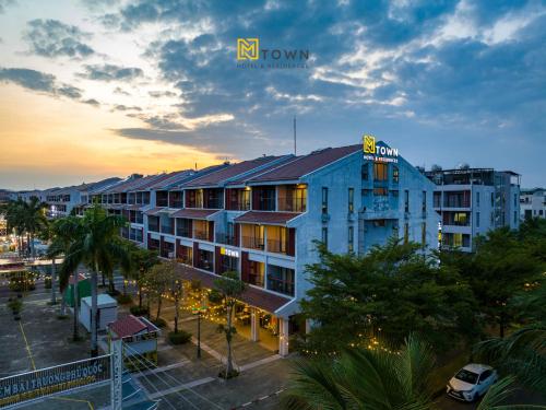 a building with a sign on the top of it at Luxy Park Hotel & Apartments - MTown in Phu Quoc