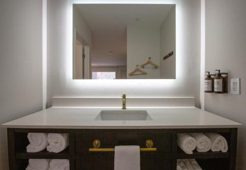 a bathroom with a sink and a mirror at Kokopelli Inn Sedona, Trademark Collection by Wyndham in Sedona