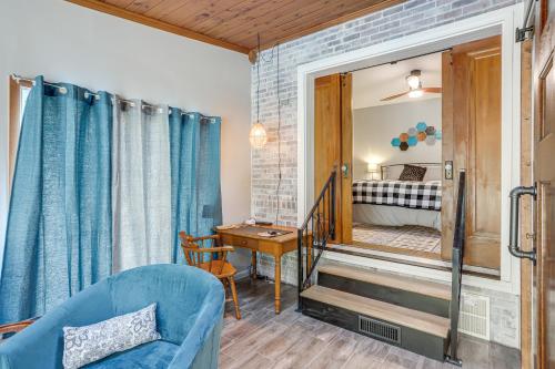 a living room with a blue couch and a bedroom at Cozy Tiffin House with Private Pool 1 Mi to Town! in Tiffin