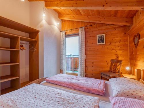 a bedroom with two beds and a window at Chalet Lisa in Piesendorf