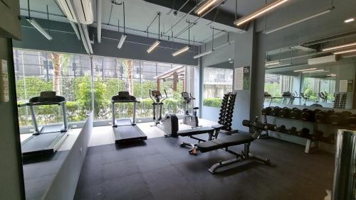 a gym with several treadmills and machines in a room at Cozy Condotel in Cebu City, Small Pets Welcome, Prime Location in Cebu City