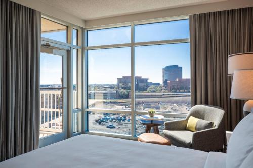 a hotel room with a bed and a large window at Renaissance Dallas Richardson Hotel in Richardson
