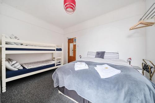 a bedroom with a large bed and bunk beds at Willin House Hotel in Blackpool