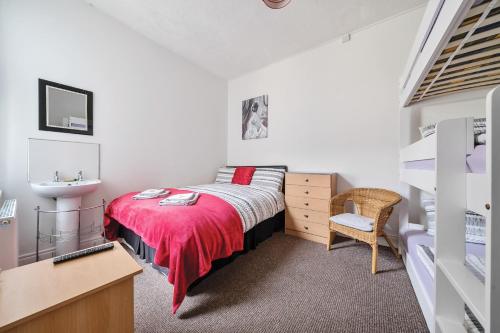 a bedroom with a bed with a red blanket at Willin House Hotel in Blackpool