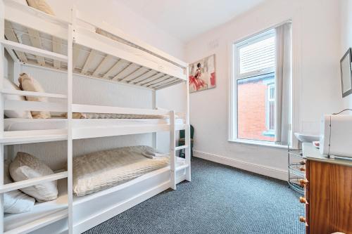 a bedroom with two bunk beds and a window at Willin House Hotel in Blackpool