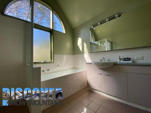 a bathroom with a sink and a mirror at Mitta Mitta in Thredbo