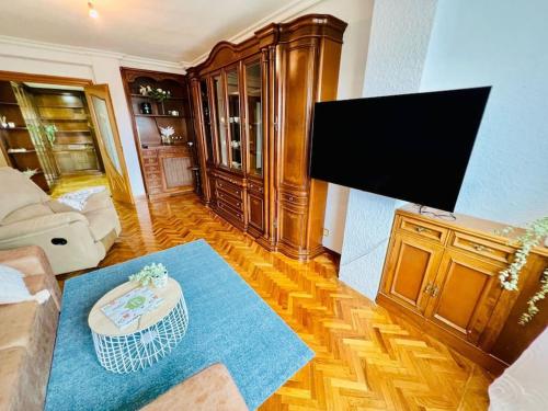 a living room with a flat screen tv at A Orillas del Pilar con parking in Zaragoza