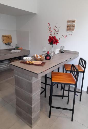 a kitchen with a large stone table and chairs at Olivos Luján in Ciudad Lujan de Cuyo