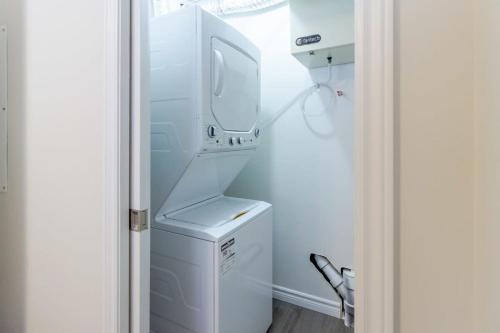 a white washer and dryer in a small kitchen at New 2BD Condo, UNB, Hospital, Golf, Patio Coffee in Saint John