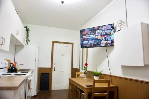 a kitchen with a table and a kitchen with a stove at Amazing DT Apartment w Parking Location Coffee in Moose Jaw