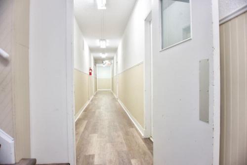a hallway of an office building with a long corridor at Cozy Studio Perfect for Business Travelers Downtown in Moose Jaw
