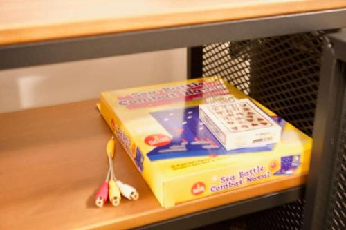 a box of cereal and a toy cell phone on a shelf at Cozy Studio Downtown Parking Coffee Location in Moose Jaw