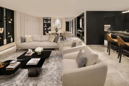 a living room with two couches and a table at Sheraton Grand Hotel, Dubai in Dubai