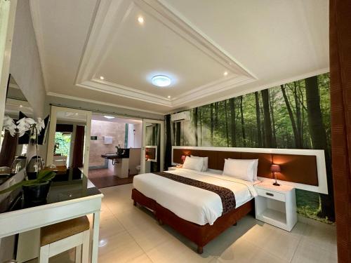 a bedroom with a bed and a large window with trees at The Taman Ayu in Seminyak
