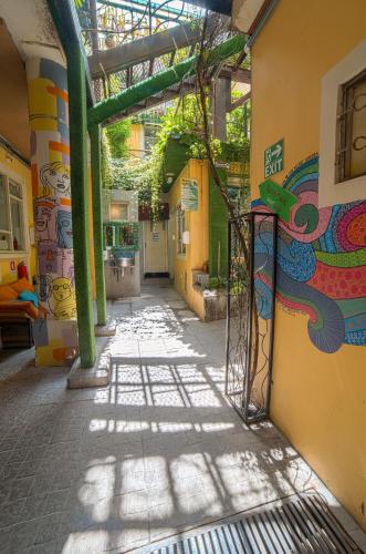 an alley with a mural on the side of a building at The Secret Garden in Quito