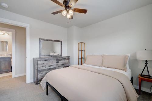 a white bedroom with a bed and a ceiling fan at Mountain View Haven in Belgrade in Belgrade