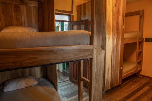 a room with two bunk beds and a window at The Secret Garden in Quito