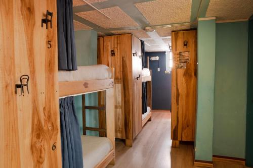 a room with two bunk beds and a hallway at The Secret Garden in Quito