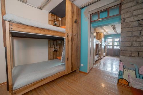 a room with bunk beds in it with a hallway at The Secret Garden in Quito