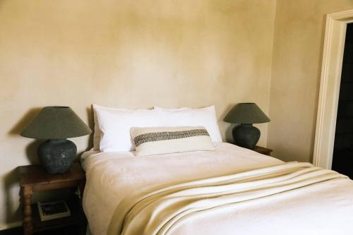 ein Schlafzimmer mit einem Bett mit zwei Lampen an Tischen in der Unterkunft The Old Clarence Brewery in Maclean
