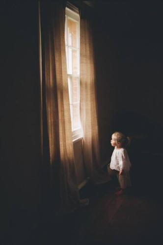 a little girl standing in front of a window at The Old Clarence Brewery in Maclean