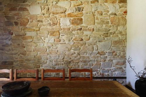 a stone wall with a table and two chairs at The Old Clarence Brewery in Maclean