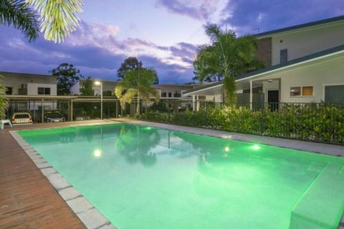 a swimming pool in front of a house at A quiet unit overlooking a reserve in Petrie