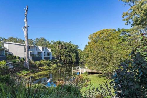 a house with a river in front of it at A quiet unit overlooking a reserve in Petrie