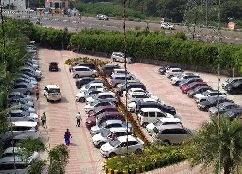 a parking lot with cars parked in it at Dwarka Palace Luxury Hotel in Madurai