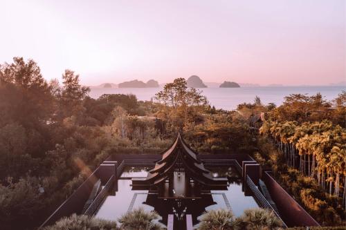 a temple in the middle of a forest with the ocean at Phulay Bay, A Ritz-Carlton Reserve in Tab Kaek Beach