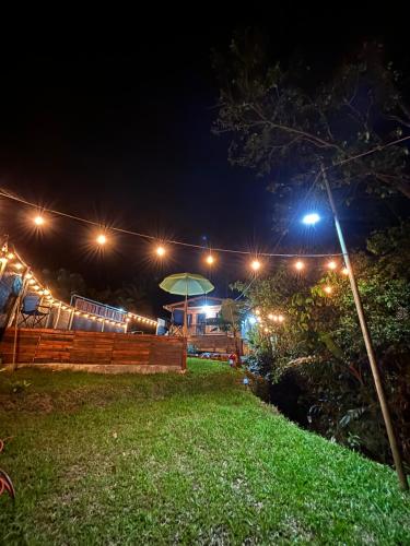 a yard at night with lights on a fence at Chalet El Riachuelo in La Suiza