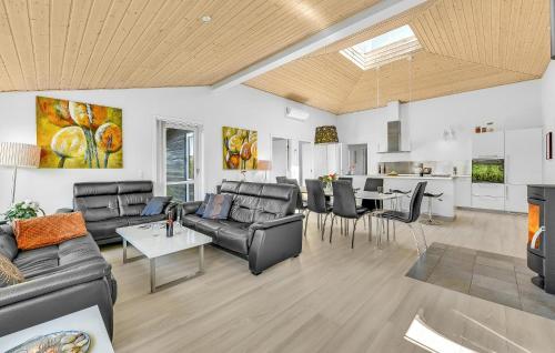 a living room with couches and a dining room at Gorgeous Home In Tarm With Sauna in Tarm