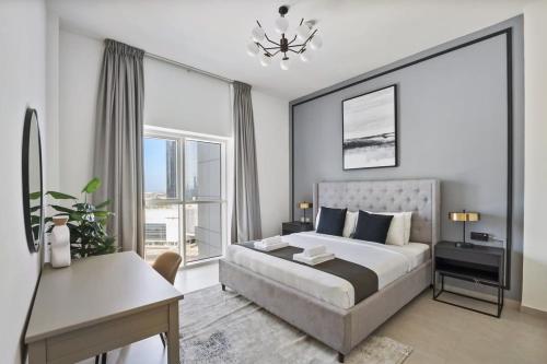 a bedroom with a large bed and a desk and a desk at Silkhaus Al Reem island Modern 1BDR in Abu Dhabi