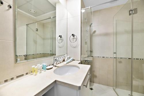 a bathroom with a sink and a shower at Silkhaus Ideal for Big Family, 5BDR with Private Roof Top in Dubai