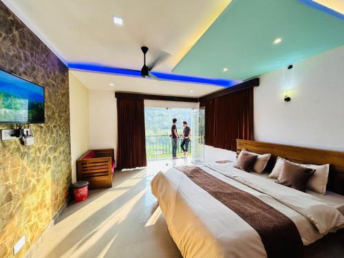 a bedroom with a large bed and a tv at Greenview in Vythiri