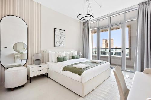 a white bedroom with a large bed and a window at Silkhaus New 1 BDR |Near Reem Mall |Al Reem Island in Abu Dhabi