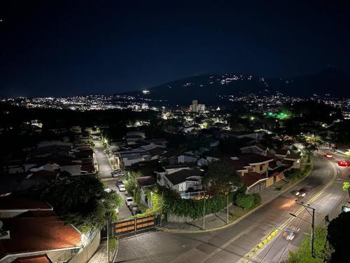 a view of a city at night with lights at Sunset 302 in Antiguo Cuscatlán